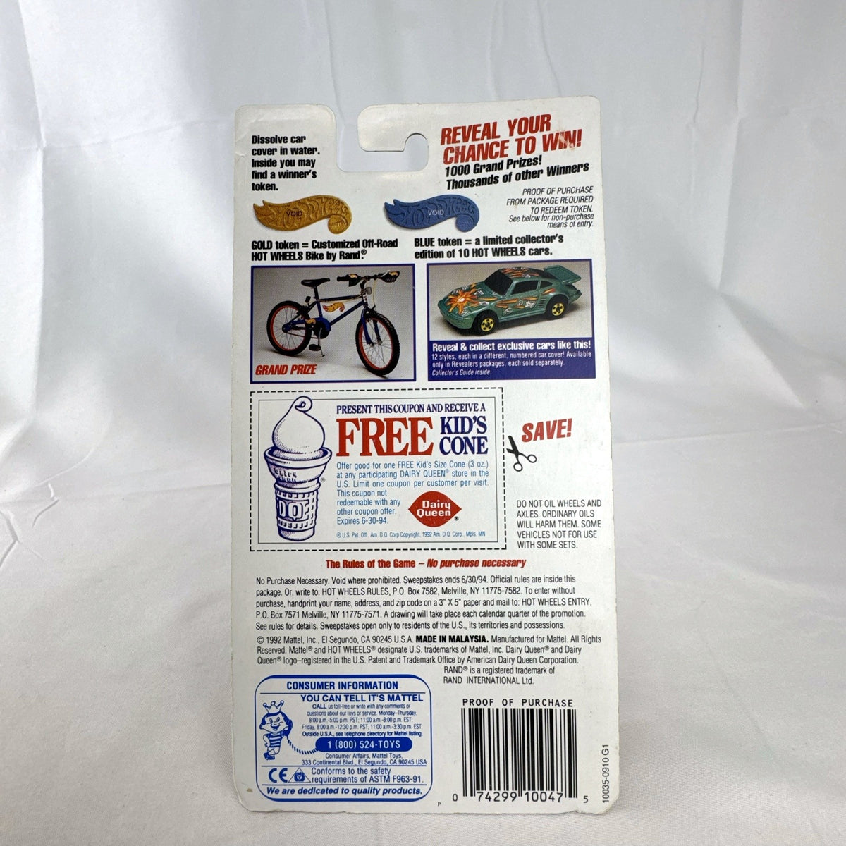 Sealed 1993 Hot Wheels Revealers 1:64 diecast car on Dairy Queen promo card with purple water-dissolvable cover