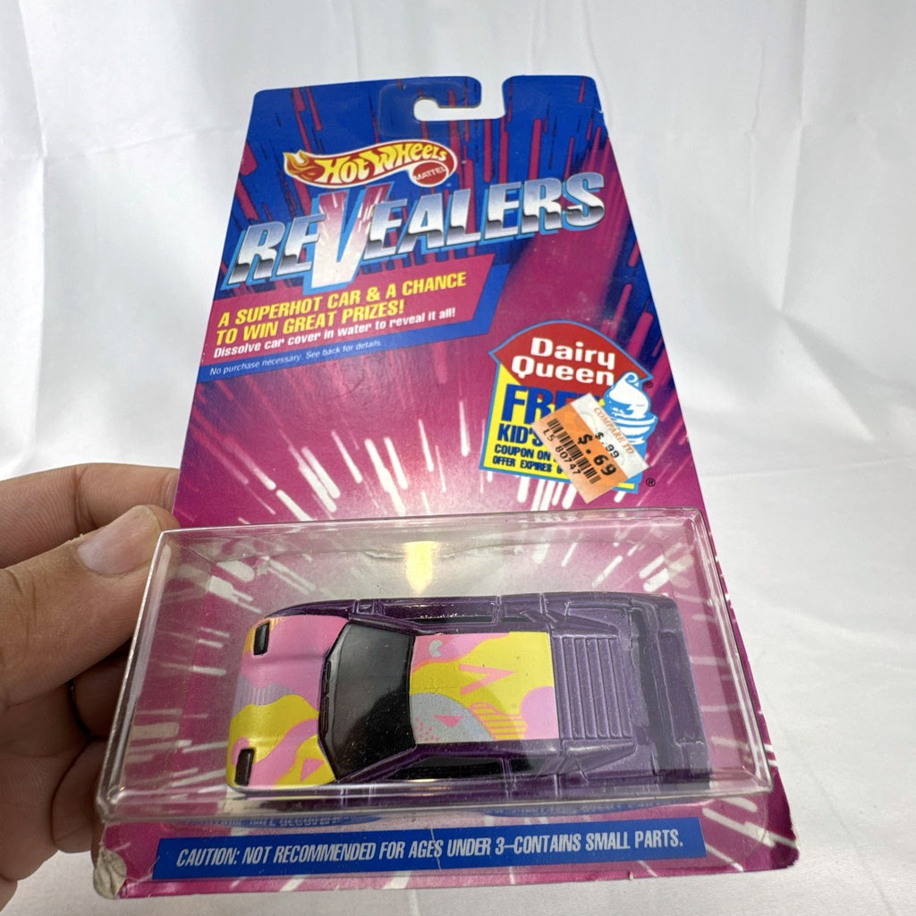 Sealed 1993 Hot Wheels Revealers 1:64 diecast car on Dairy Queen promo card with purple water-dissolvable cover