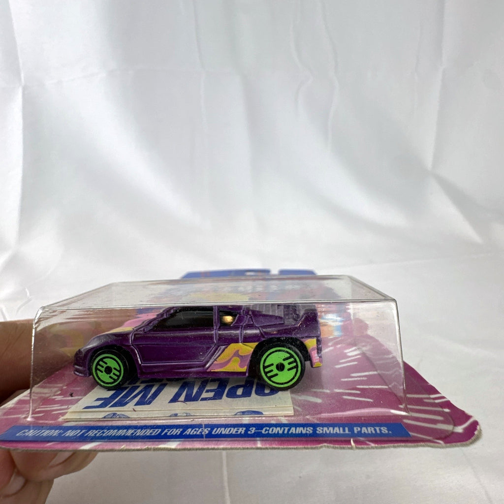 Sealed 1993 Hot Wheels Revealers 1:64 diecast car on Dairy Queen promo card with purple water-dissolvable cover