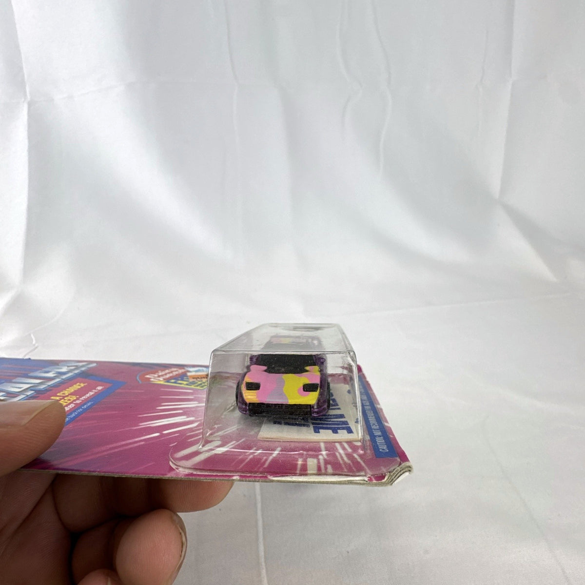 Sealed 1993 Hot Wheels Revealers 1:64 diecast car on Dairy Queen promo card with purple water-dissolvable cover