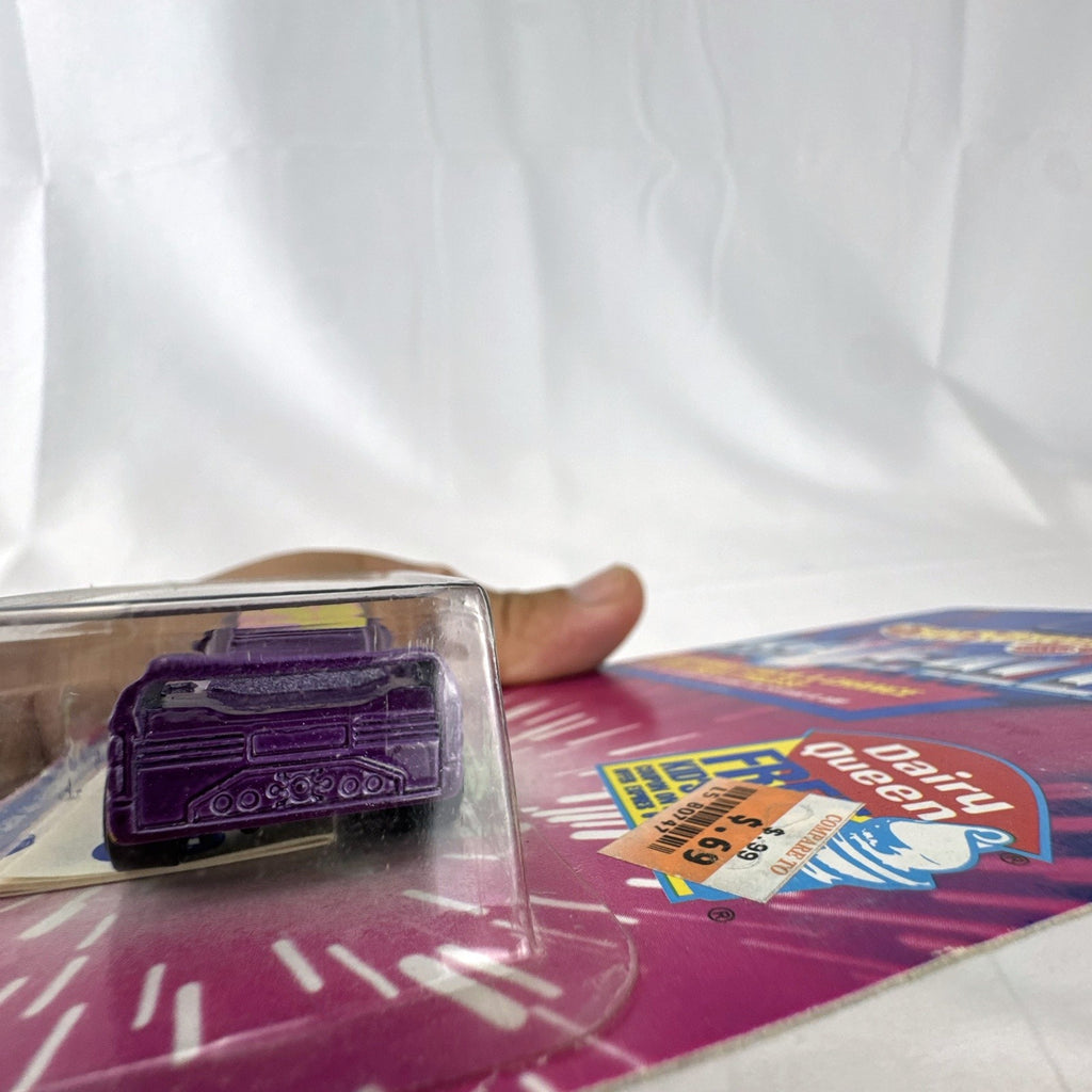 Sealed 1993 Hot Wheels Revealers 1:64 diecast car on Dairy Queen promo card with purple water-dissolvable cover