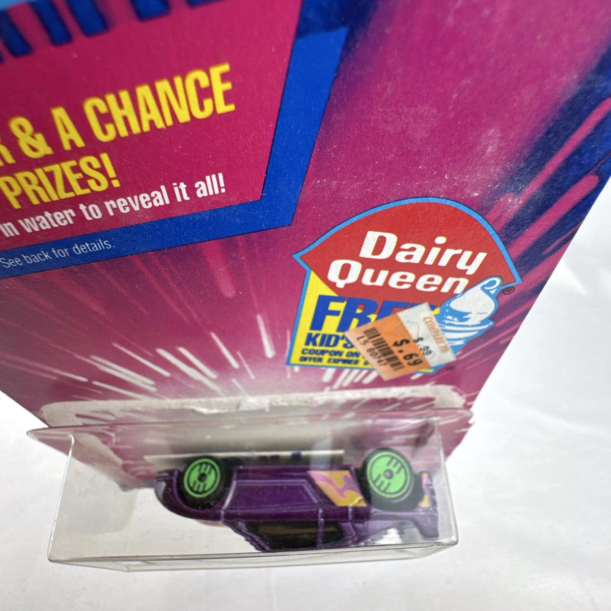 Sealed 1993 Hot Wheels Revealers 1:64 diecast car on Dairy Queen promo card with purple water-dissolvable cover