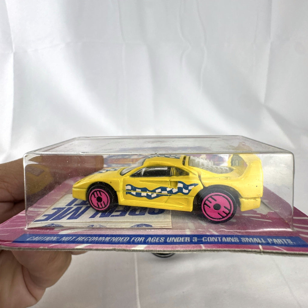 1993 Hot Wheels Ferrari F40 Dairy Queen Revealers diecast car in yellow with hot pink wheels on card