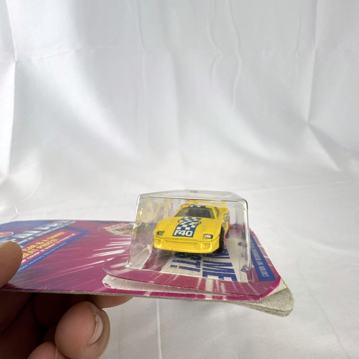 1993 Hot Wheels Ferrari F40 Dairy Queen Revealers diecast car in yellow with hot pink wheels on card