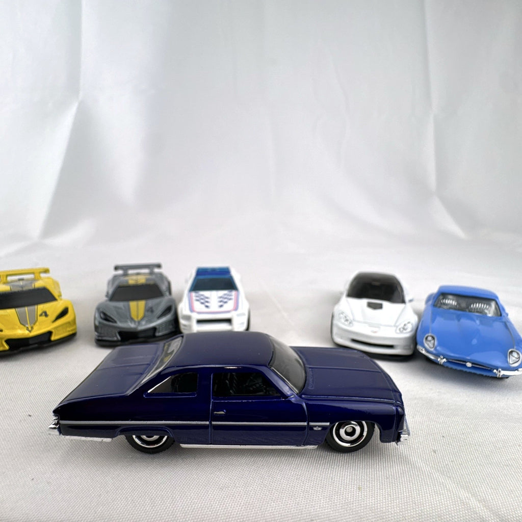 Set of 6 loose 1:64 scale Hot Wheels and Matchbox diecast cars including Corvette C8.R, Mustang, Caprice, and Jaguar E-Type