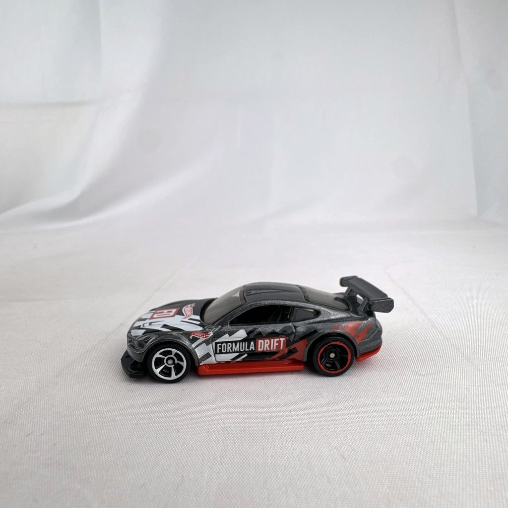 Hot Wheels 1:64 Custom '18 Ford Mustang GT Formula Drift diecast car in dark gray with red chassis base