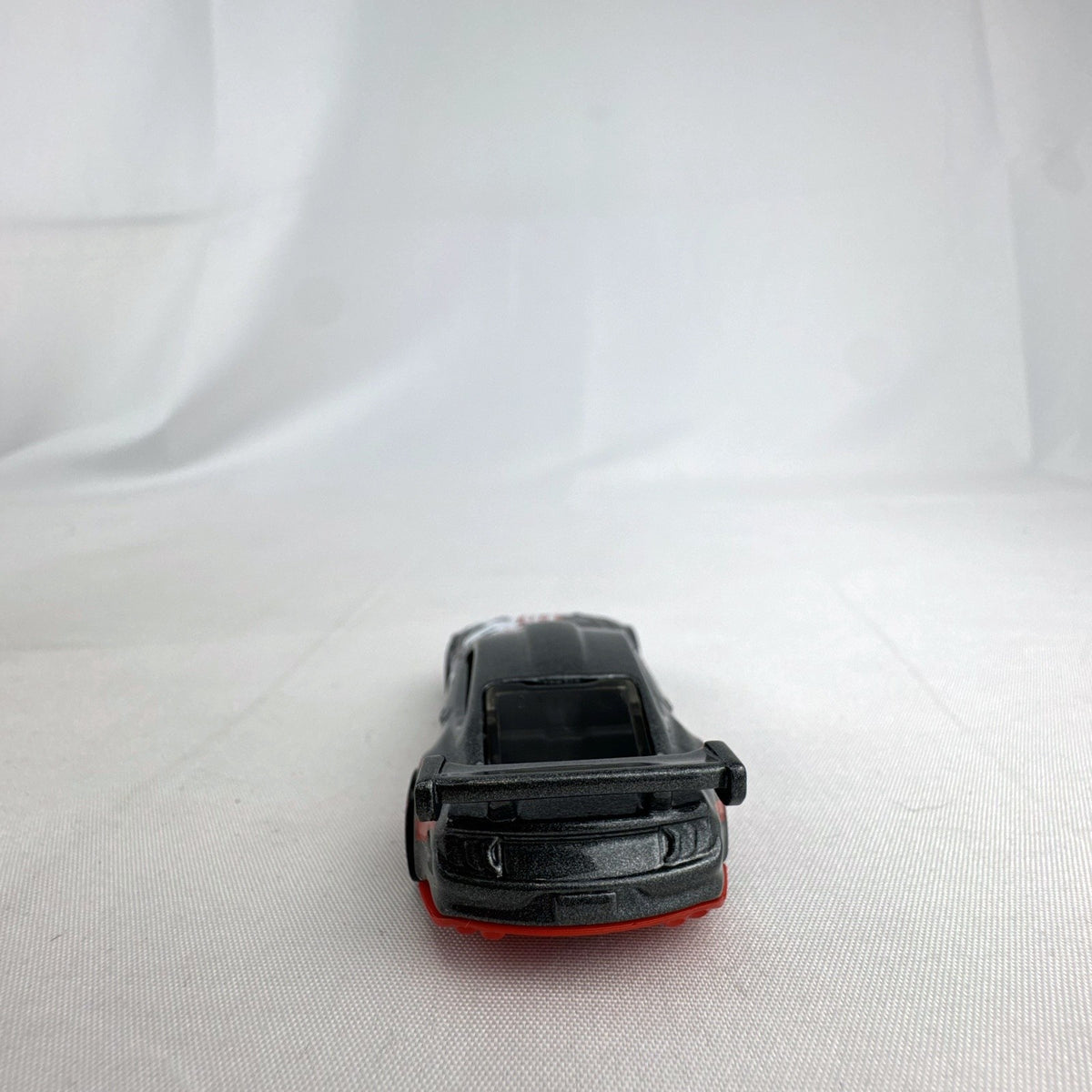 Hot Wheels 1:64 Custom '18 Ford Mustang GT Formula Drift diecast car in dark gray with red chassis base