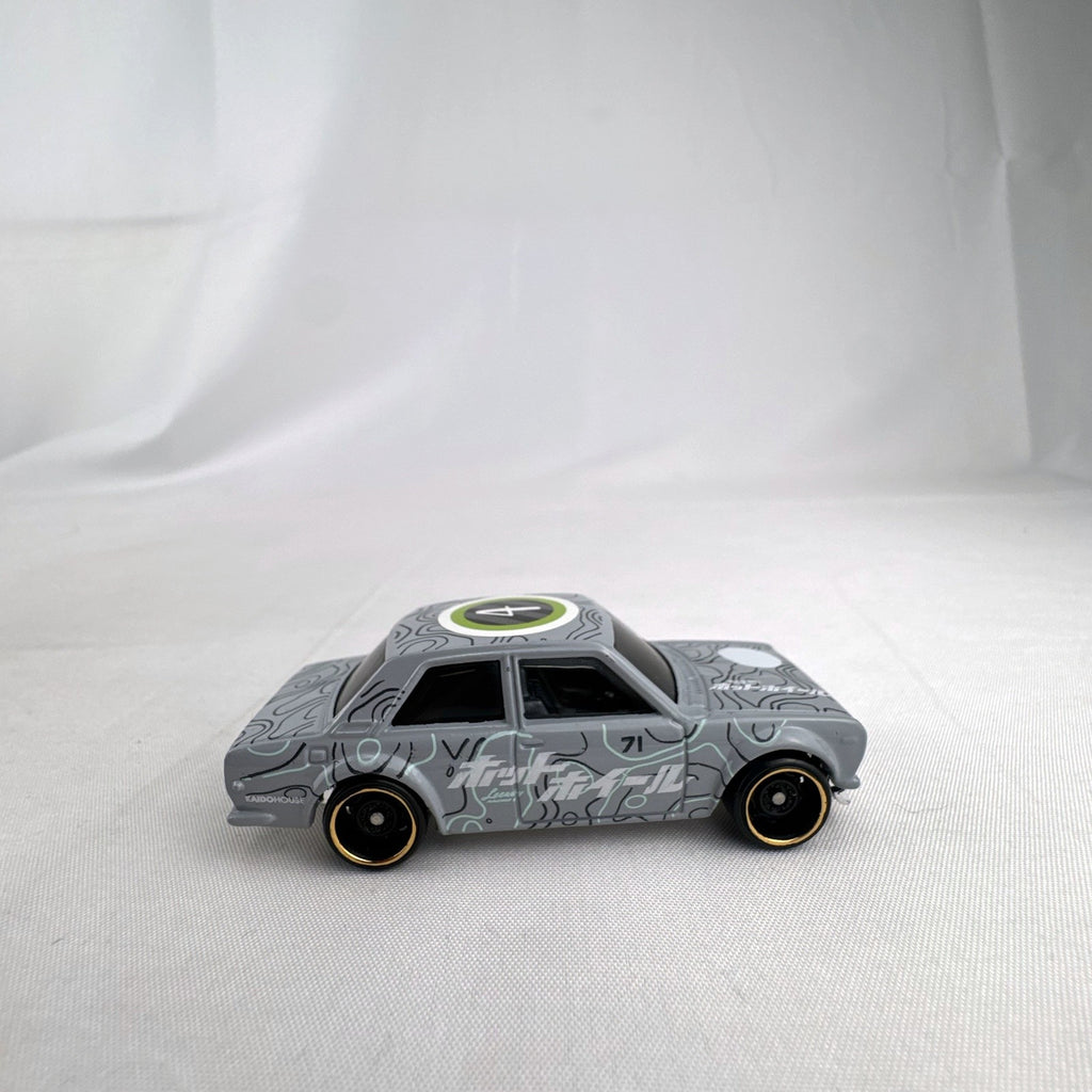 Hot Wheels 1:64 scale 1971 Datsun Bluebird 510 diecast car in grey with Kaido House topographic graphics