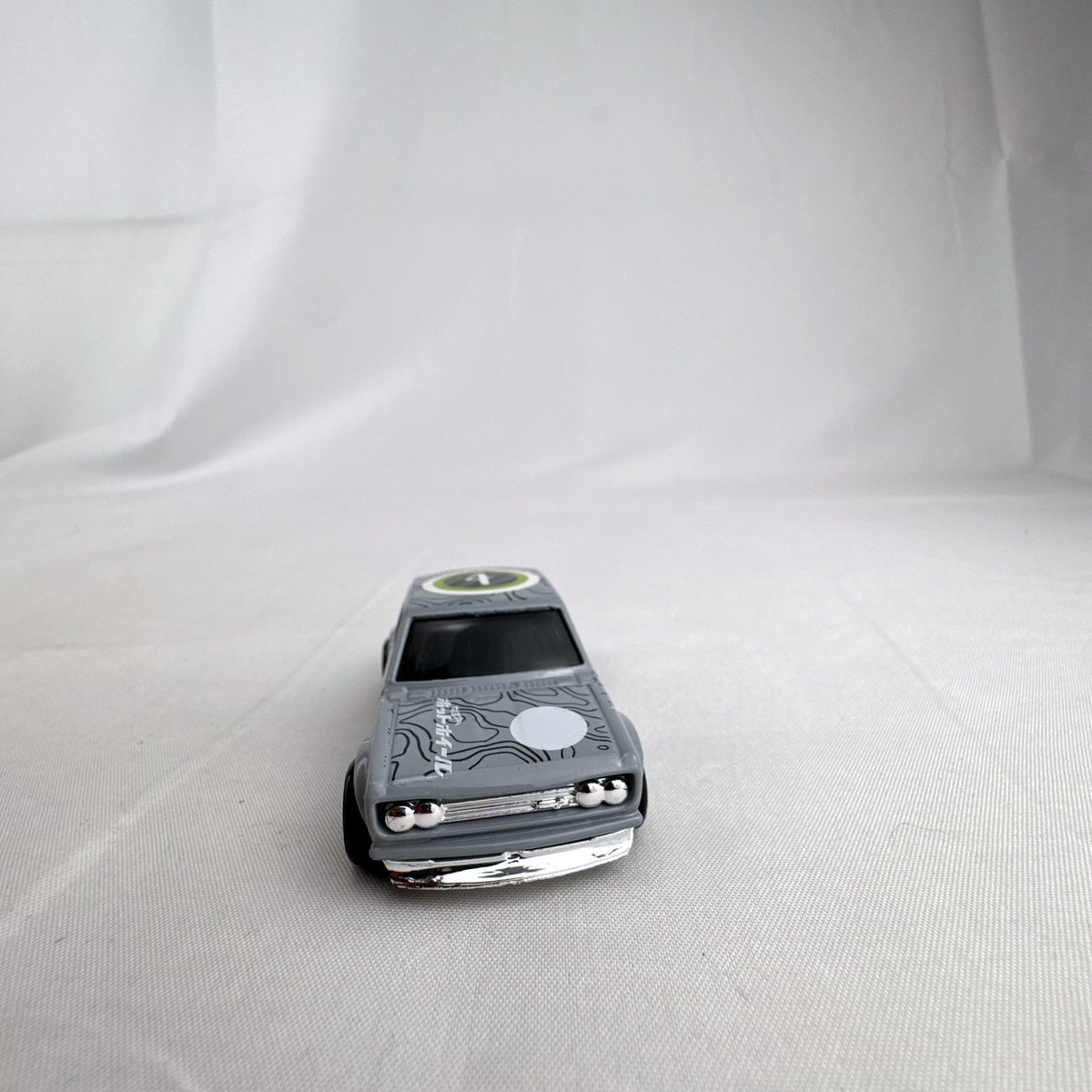 Hot Wheels 1:64 scale 1971 Datsun Bluebird 510 diecast car in grey with Kaido House topographic graphics