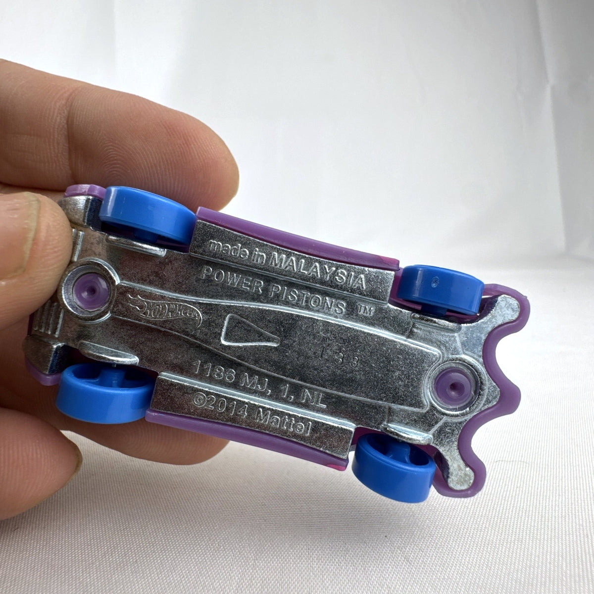 Hot Wheels 1:64 scale Power Pistons diecast car in purple from the 2019 Spring Circuit series