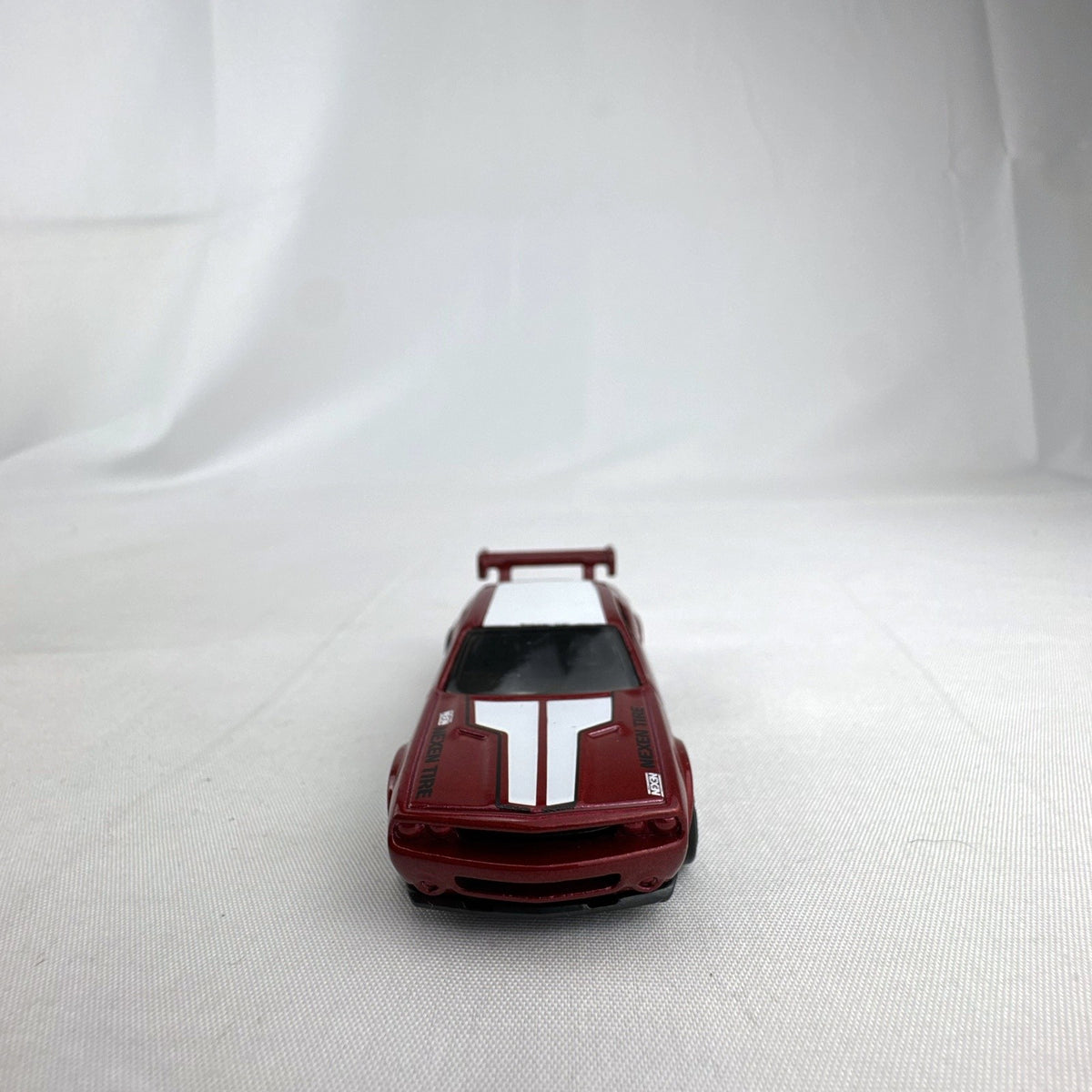 Hot Wheels 1:64 diecast Dodge Challenger Drift Car in metallic red with Mopar and Nexen Tire graphics