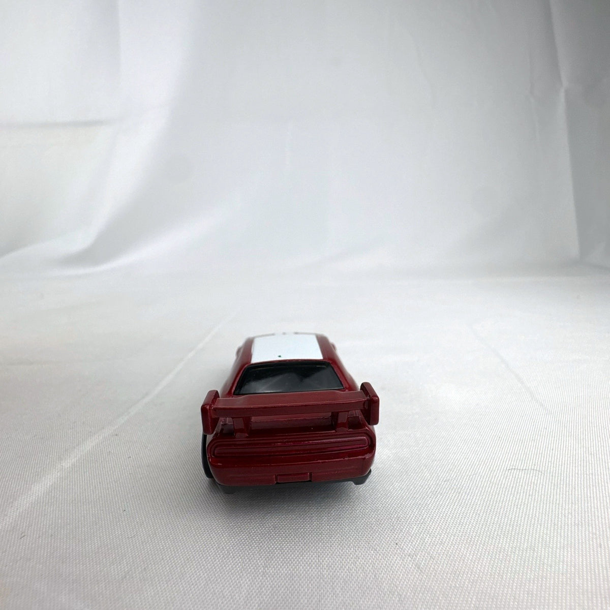 Hot Wheels 1:64 diecast Dodge Challenger Drift Car in metallic red with Mopar and Nexen Tire graphics