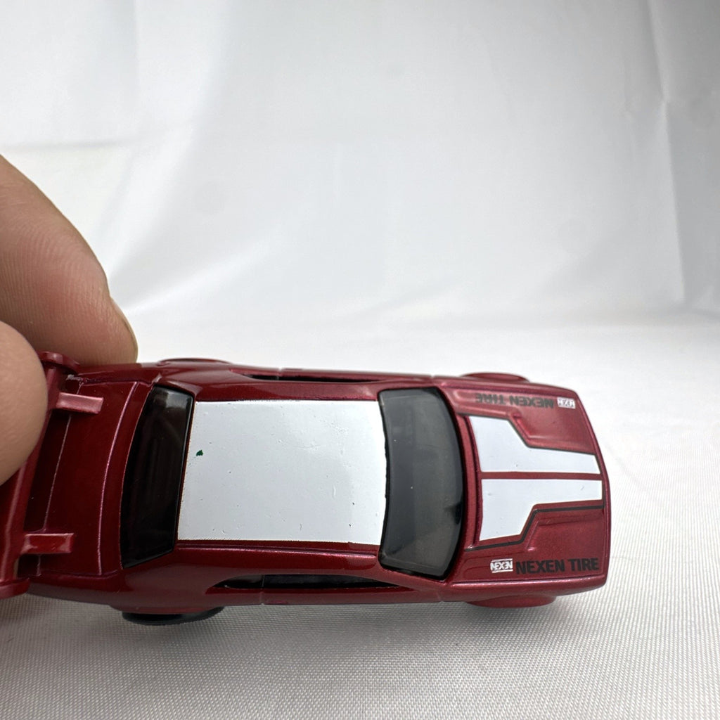 Hot Wheels 1:64 diecast Dodge Challenger Drift Car in metallic red with Mopar and Nexen Tire graphics