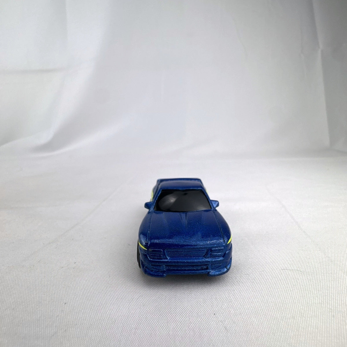Matchbox 1995 The Buster 1:64 scale custom diecast pickup truck in metallic blue with yellow side graphics