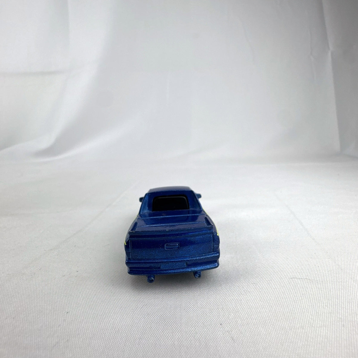 Matchbox 1995 The Buster 1:64 scale custom diecast pickup truck in metallic blue with yellow side graphics