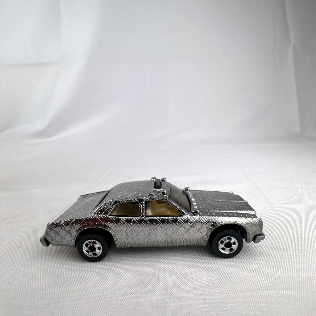 Hot Wheels 1:64 scale vintage Sheriff Patrol diecast car featuring an embossed silver chrome diamond finish