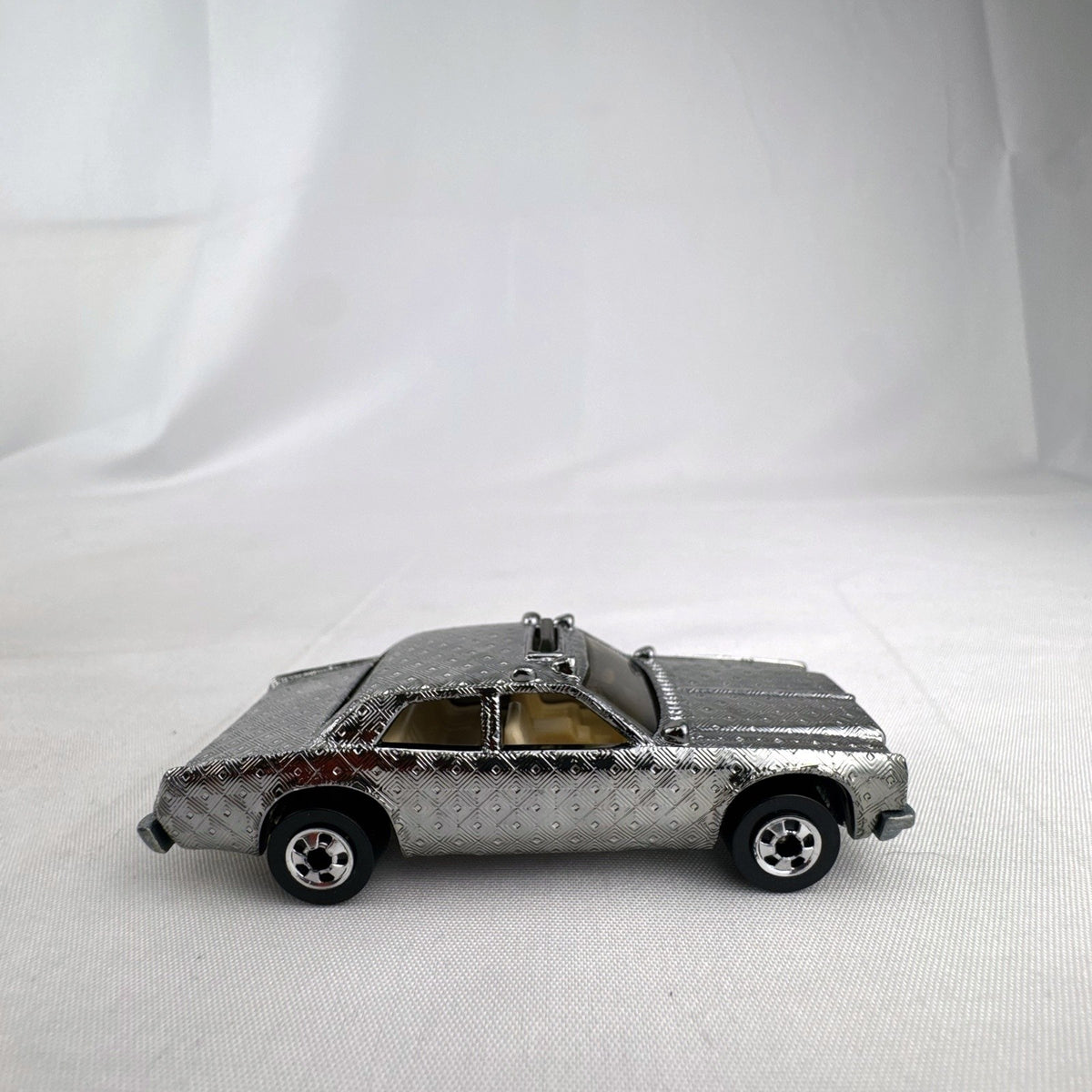 Hot Wheels 1:64 scale vintage Sheriff Patrol diecast car featuring an embossed silver chrome diamond finish