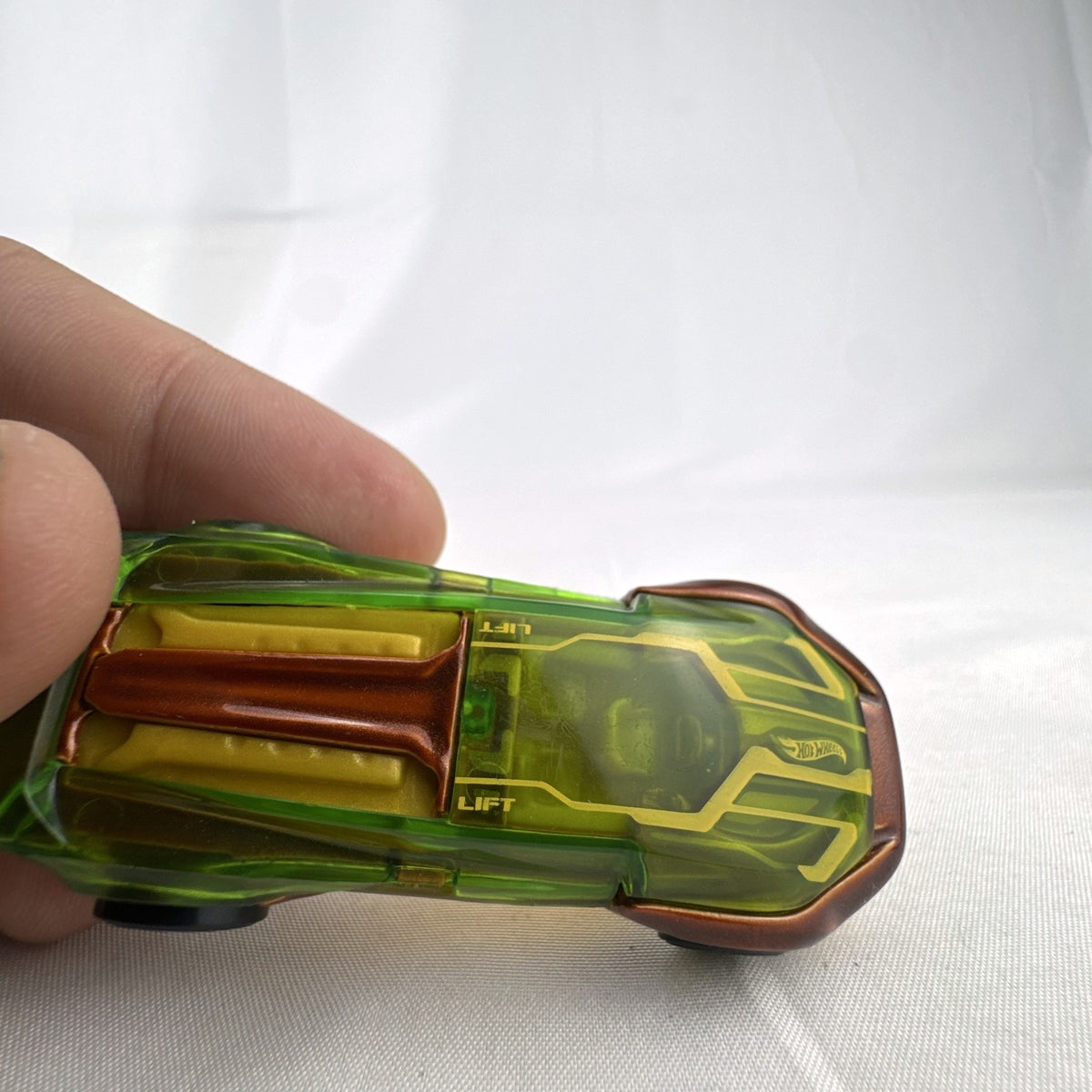 Hot Wheels El Viento 1:64 scale diecast car with translucent green canopy and yellow accents