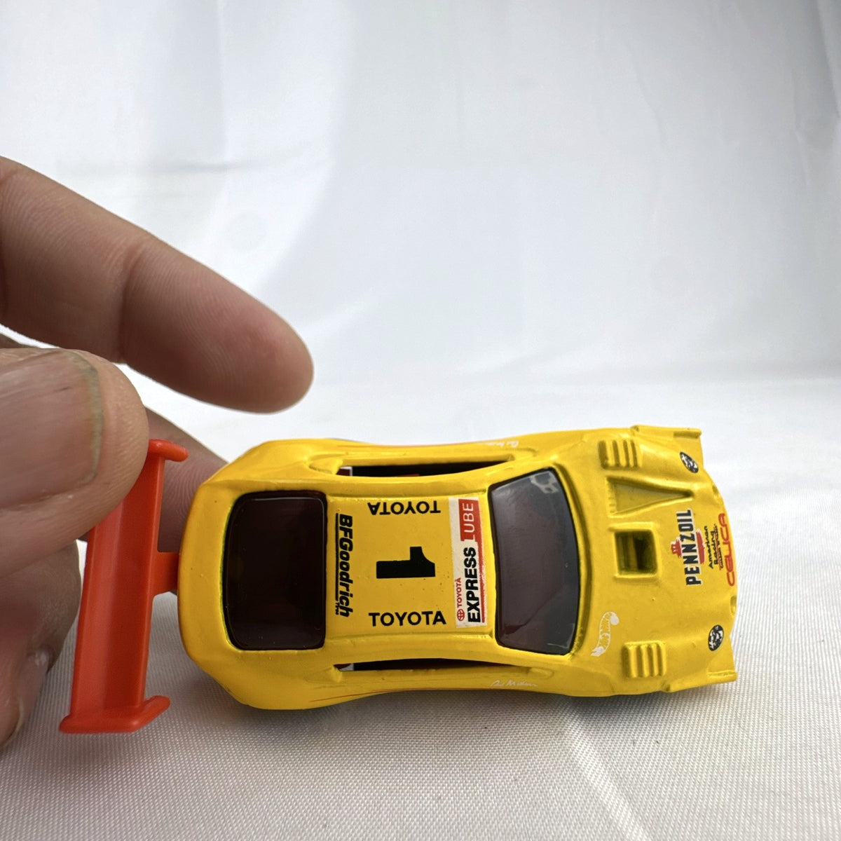 Hot Wheels 1:64 scale 1998 Toyota Pikes Peak Celica diecast race car in yellow Pennzoil livery