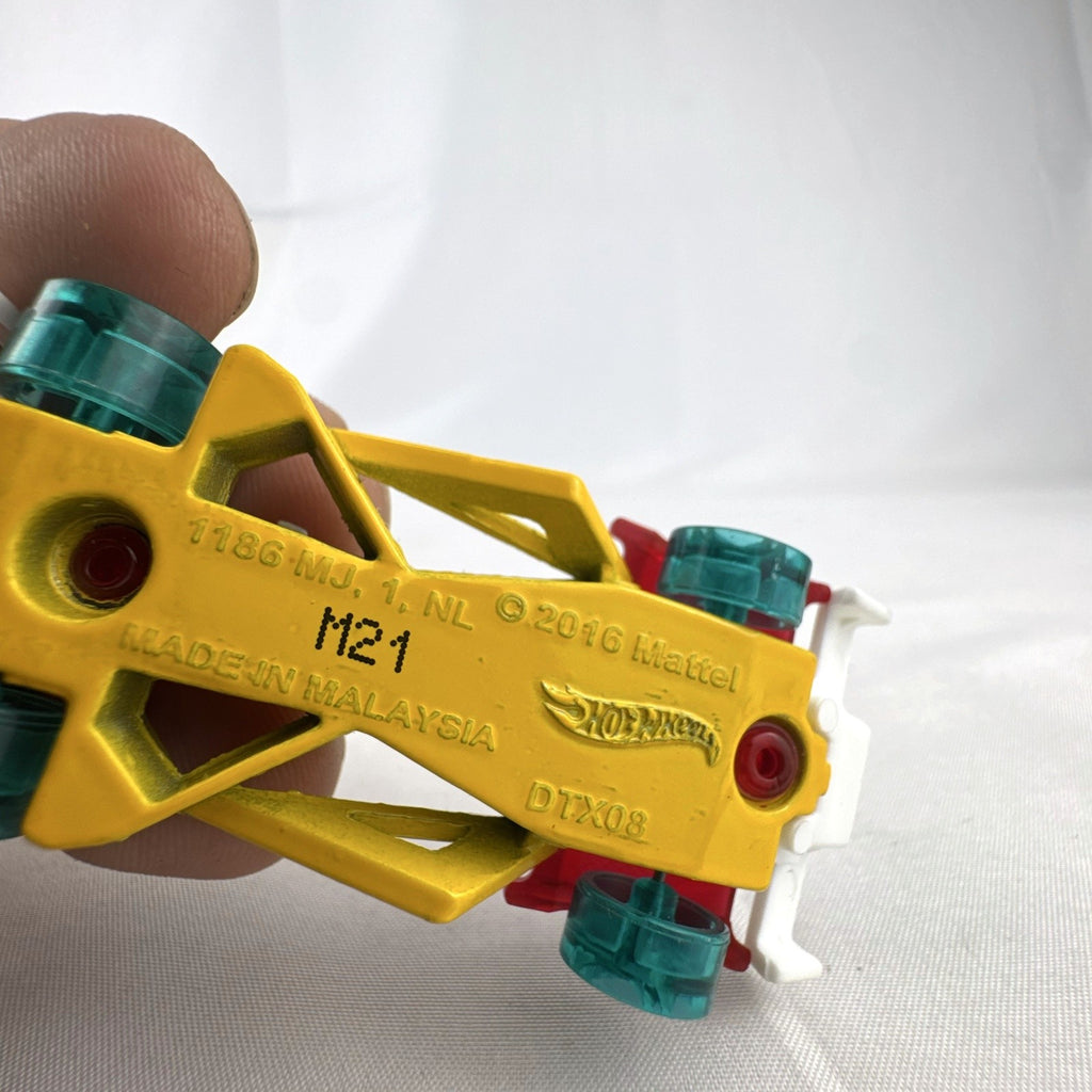 Hot Wheels Track Hammer X-Raycers diecast race car in translucent red with yellow chassis and teal wheels