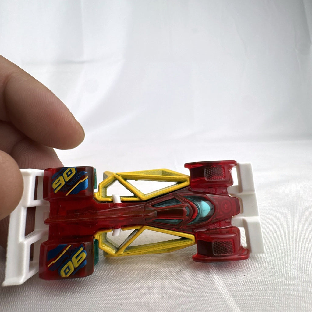 Hot Wheels Track Hammer X-Raycers diecast race car in translucent red with yellow chassis and teal wheels