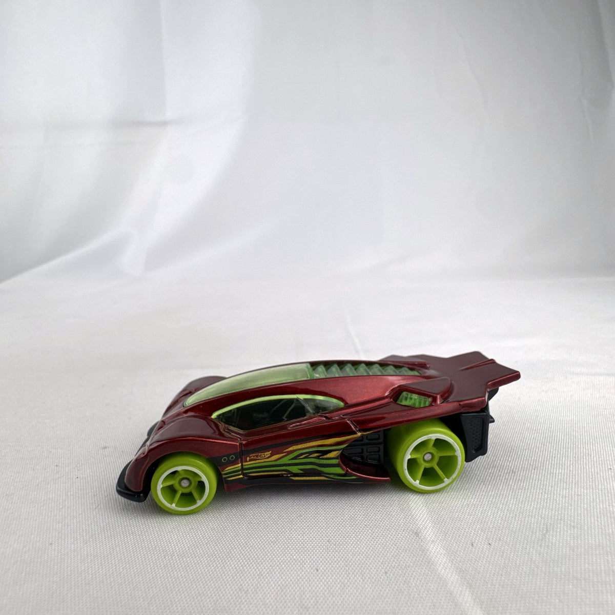 Hot Wheels Side Draft 1:64 scale diecast car in metallic red with lime green wheels