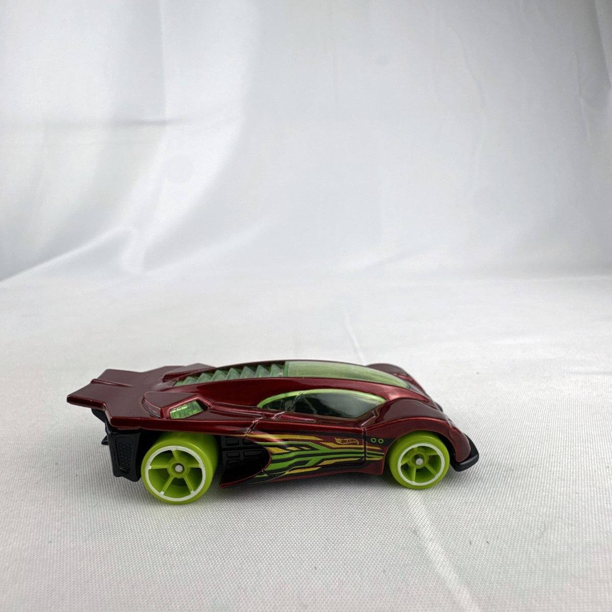 Hot Wheels Side Draft 1:64 scale diecast car in metallic red with lime green wheels