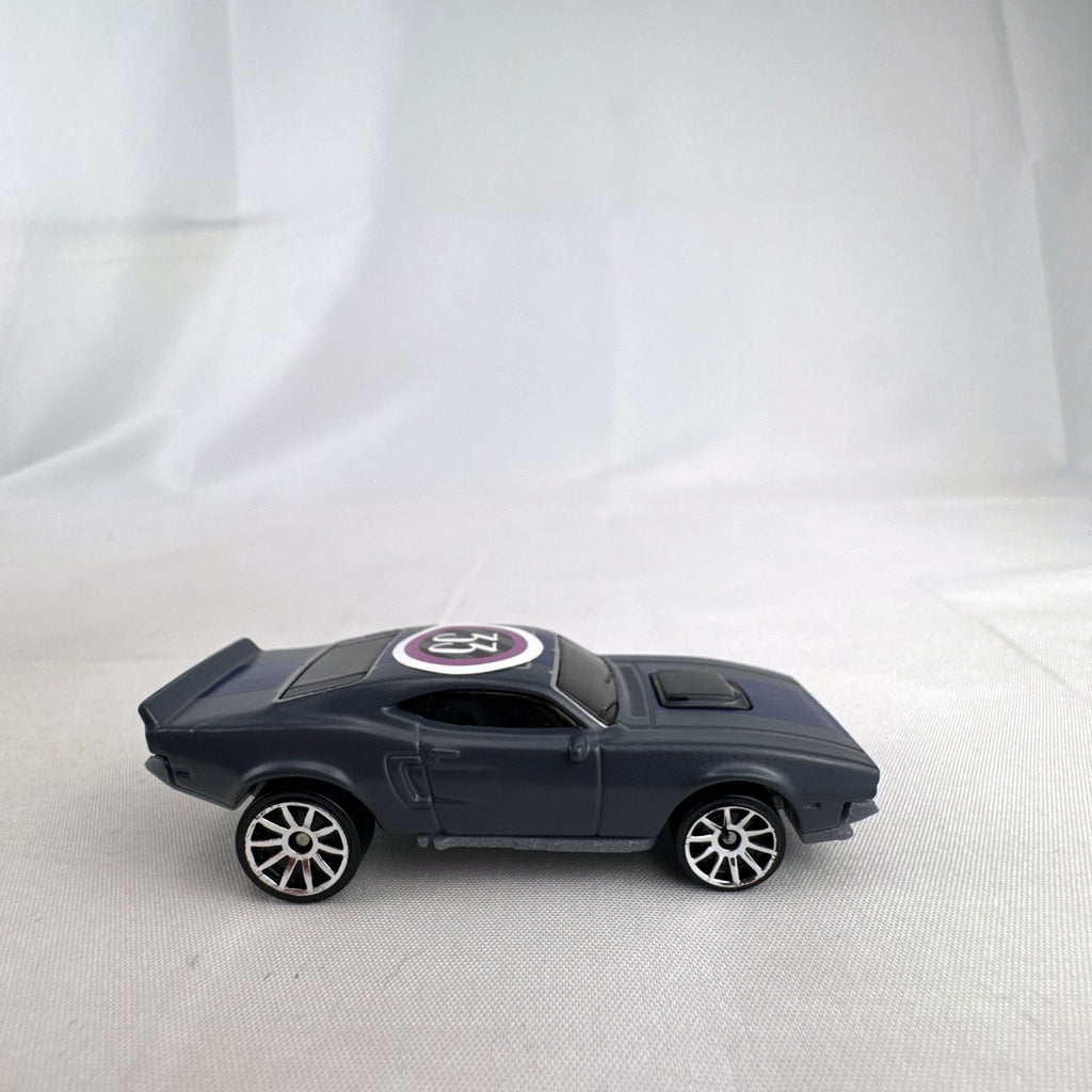 Hot Wheels 1:64 scale Ion Motors Thresher diecast car in gray with blue racing stripes from Fast and Furious Spy Racers