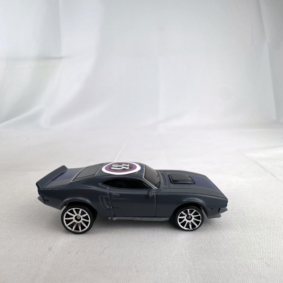 Hot Wheels 1:64 scale Ion Motors Thresher diecast car in gray with blue racing stripes from Fast and Furious Spy Racers