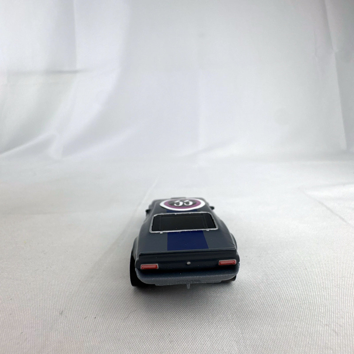 Hot Wheels 1:64 scale Ion Motors Thresher diecast car in gray with blue racing stripes from Fast and Furious Spy Racers