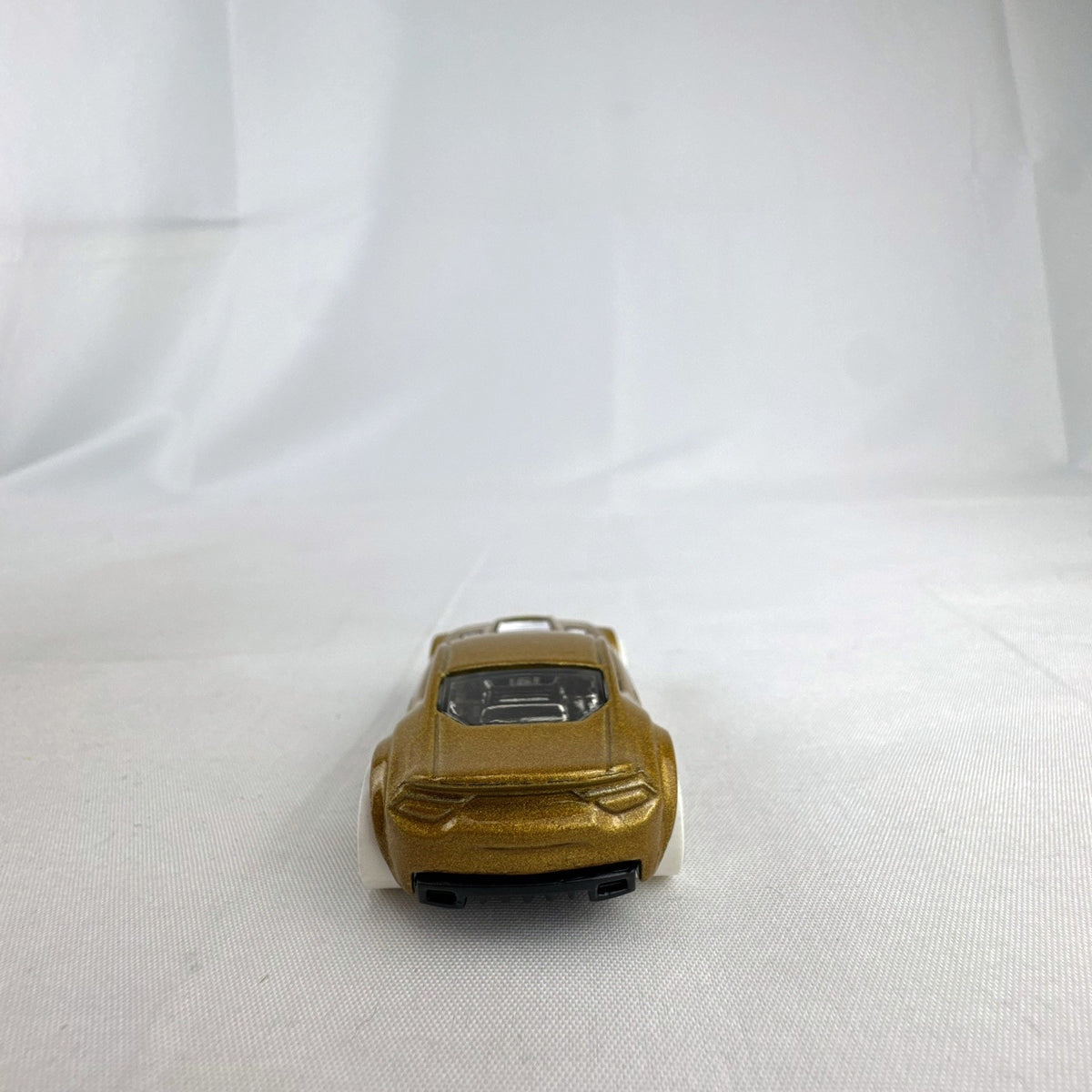 Hot Wheels Torque Twister diecast car in metallic gold with white wheels from the 2020 Winter series