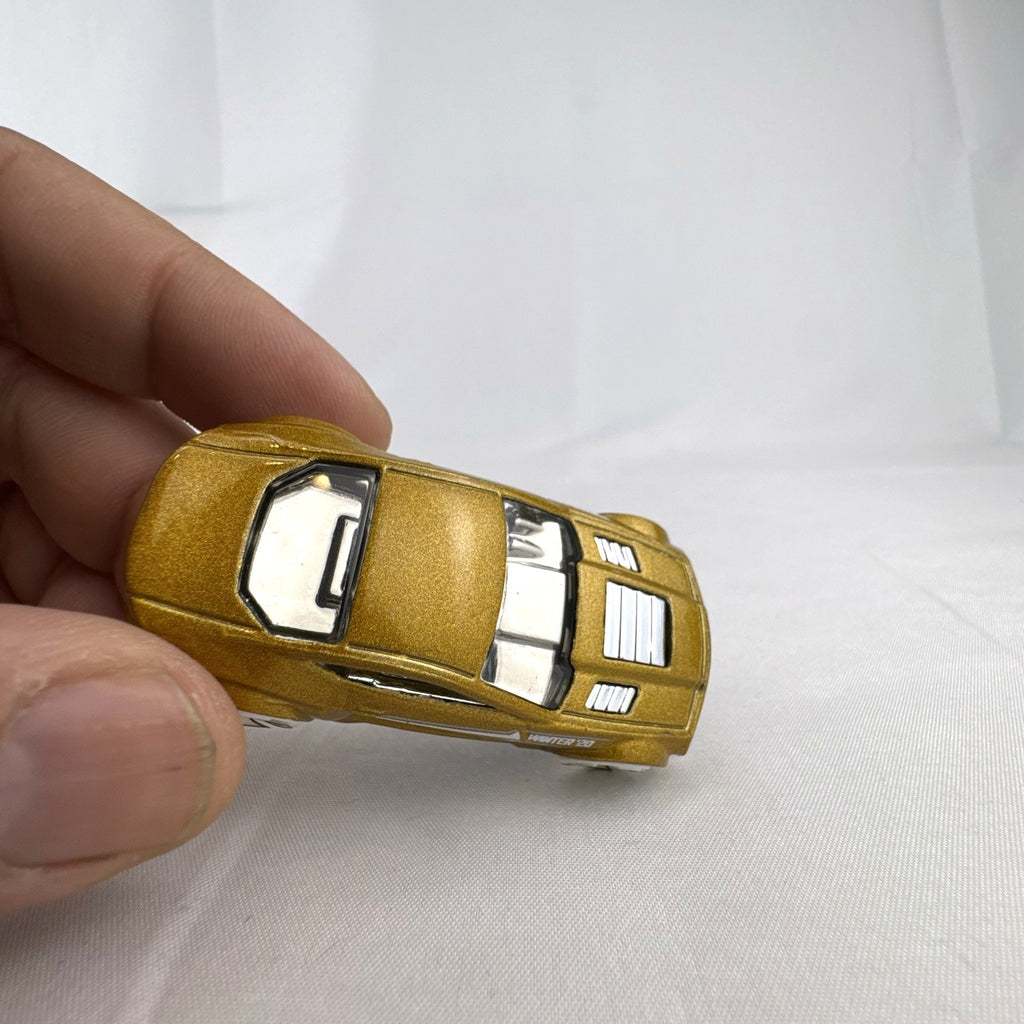 Hot Wheels Torque Twister diecast car in metallic gold with white wheels from the 2020 Winter series