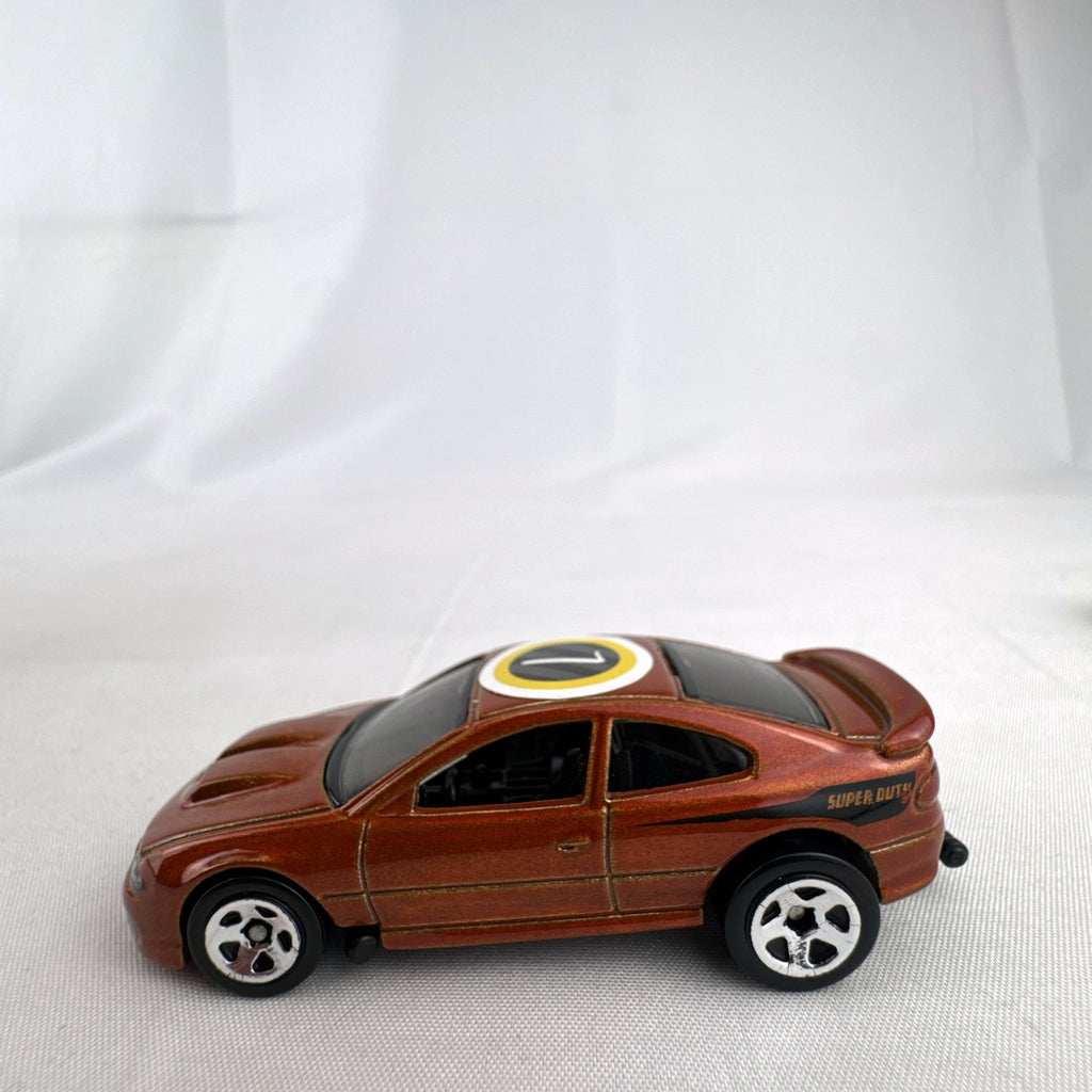 Hot Wheels 2006 Pontiac GTO Flying Customs diecast drag car in metallic copper orange