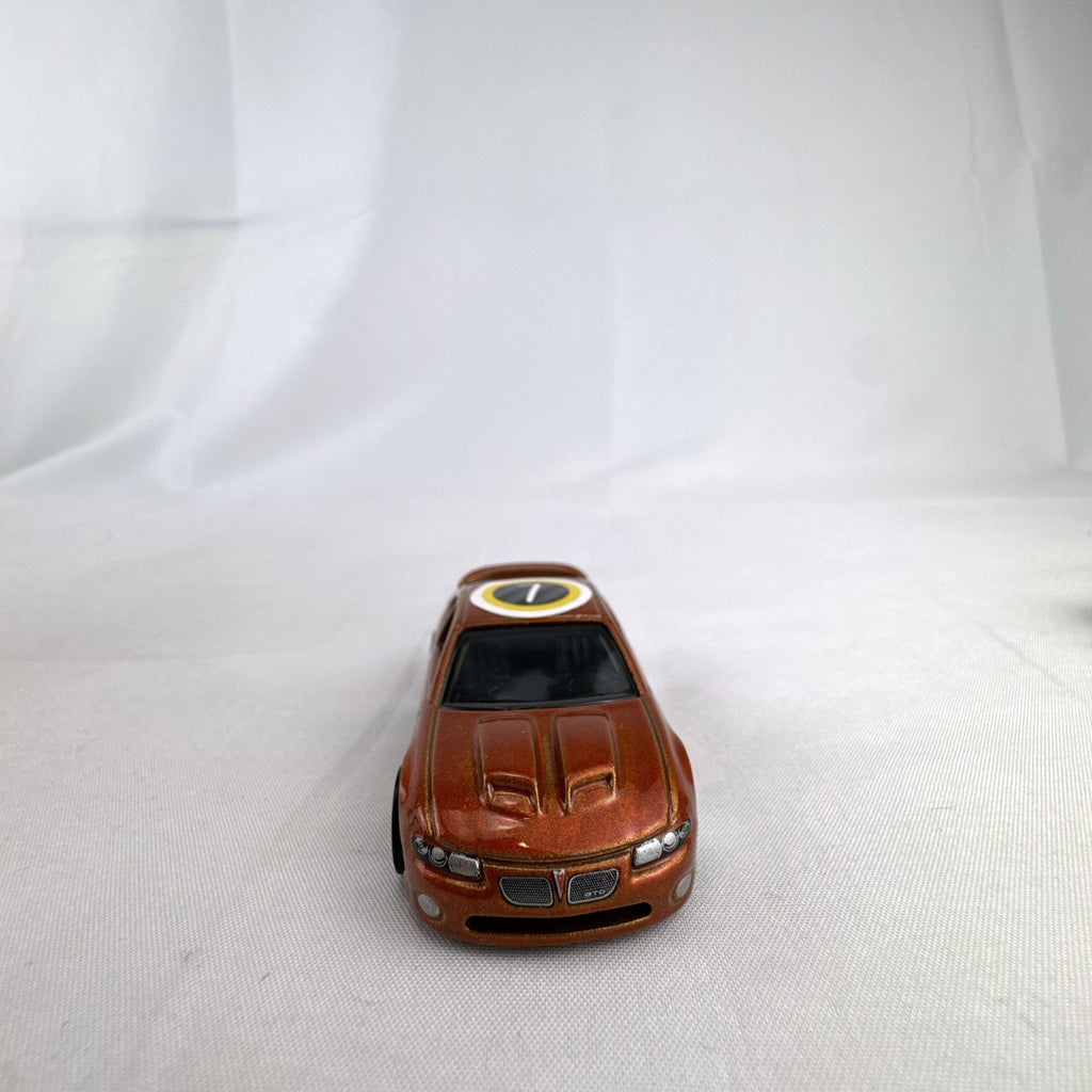 Hot Wheels 2006 Pontiac GTO Flying Customs diecast drag car in metallic copper orange