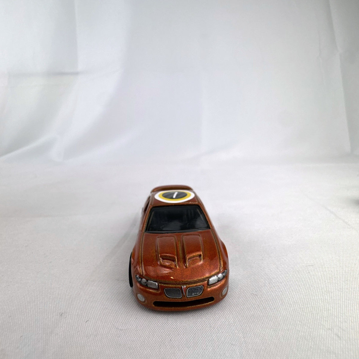 Hot Wheels 2006 Pontiac GTO Flying Customs diecast drag car in metallic copper orange