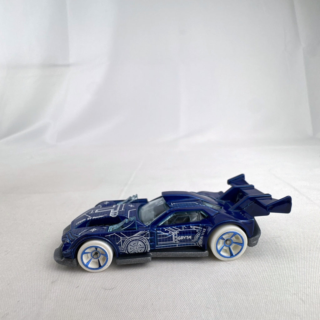 Hot Wheels 1:64 GT Hunter HW Art Cars diecast model in blue blueprint design with white wheels