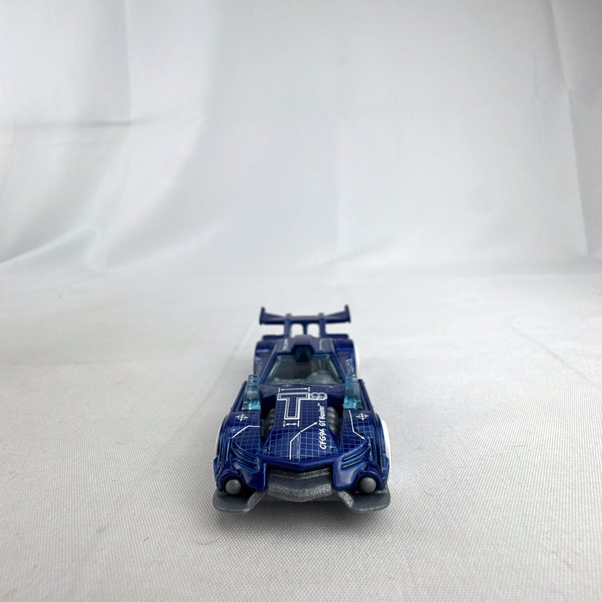 Hot Wheels 1:64 GT Hunter HW Art Cars diecast model in blue blueprint design with white wheels