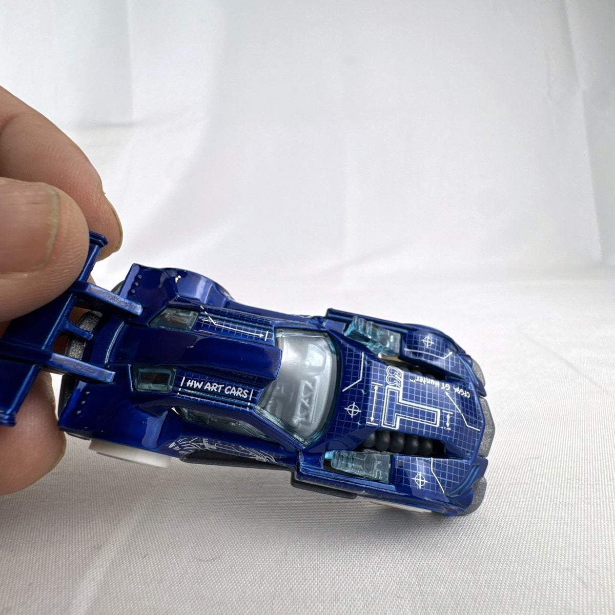 Hot Wheels 1:64 GT Hunter HW Art Cars diecast model in blue blueprint design with white wheels