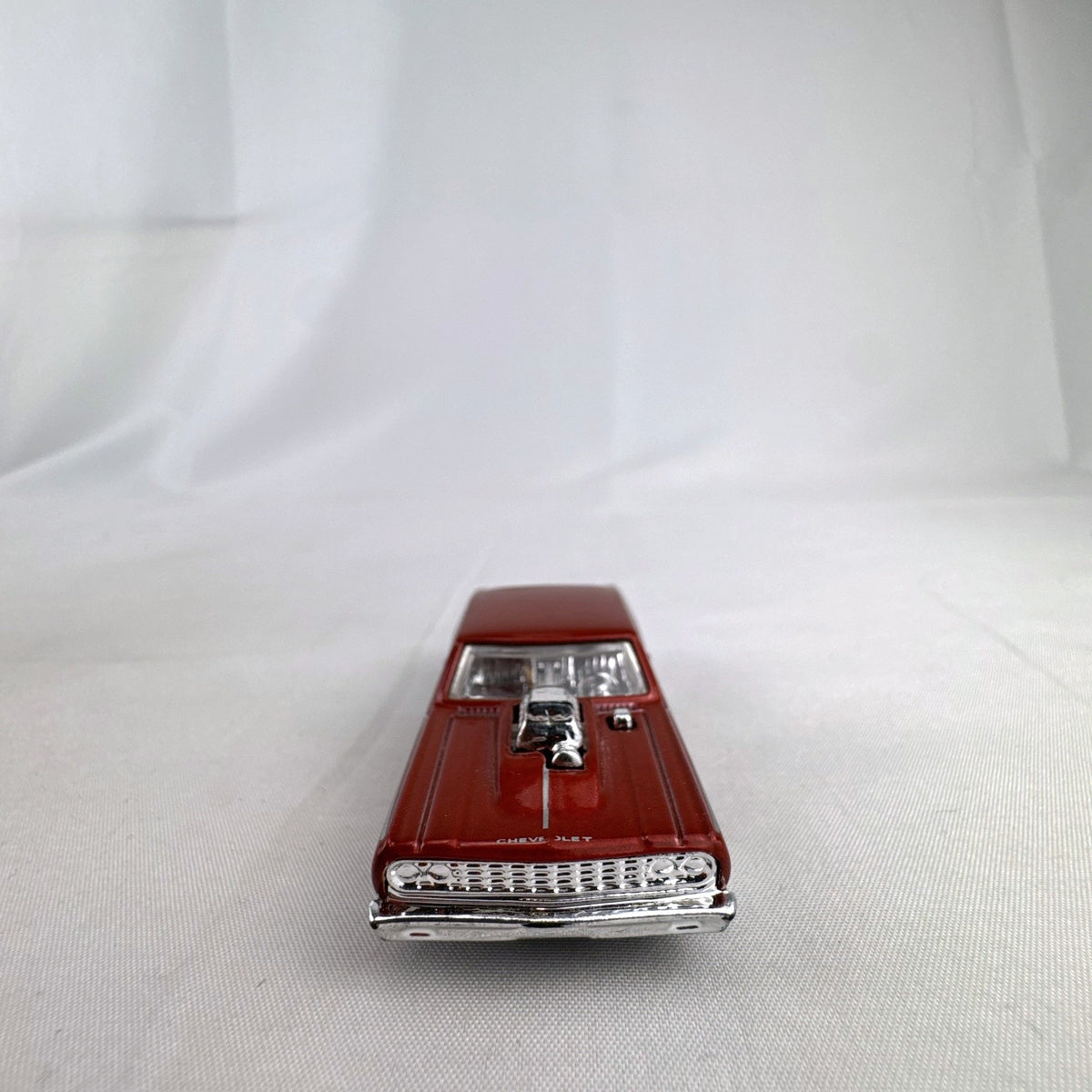 Hot Wheels 1:64 scale 1964 Chevrolet Chevelle SS diecast car in metallic dark red with exposed chrome blower