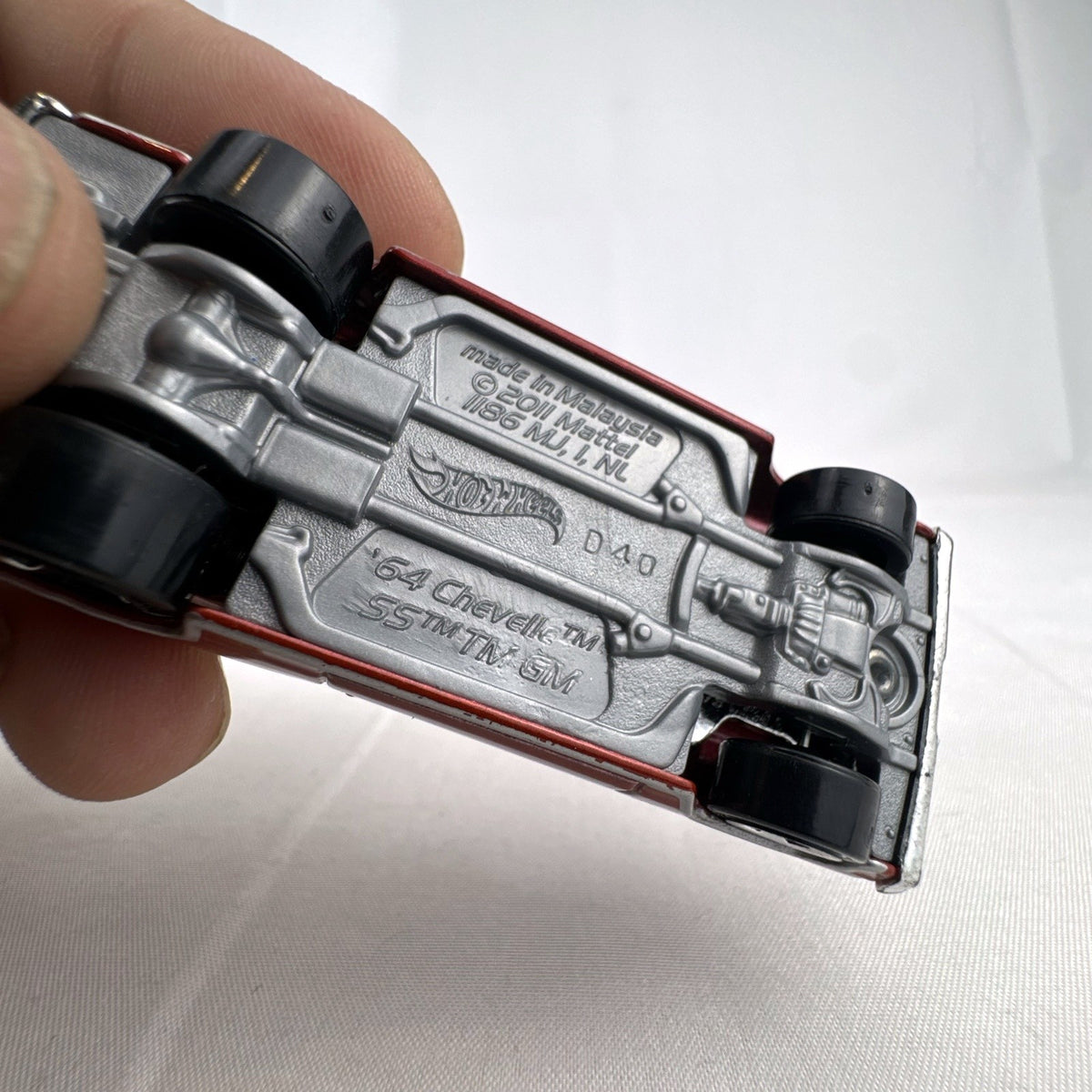 Hot Wheels 1:64 scale 1964 Chevrolet Chevelle SS diecast car in metallic dark red with exposed chrome blower
