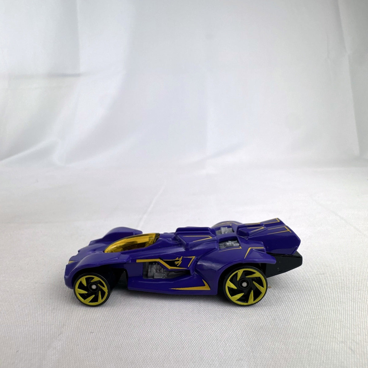 Hot Wheels RD-02 1:64 scale diecast race car in purple with yellow accents and wheels