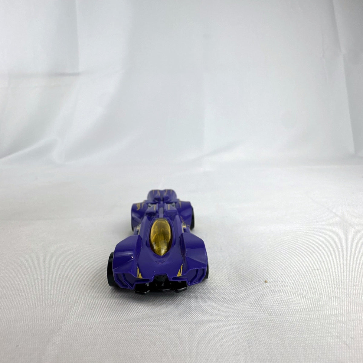 Hot Wheels RD-02 1:64 scale diecast race car in purple with yellow accents and wheels