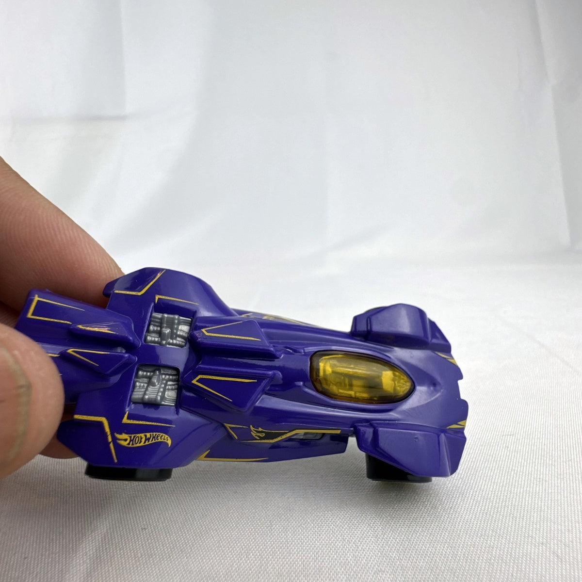 Hot Wheels RD-02 1:64 scale diecast race car in purple with yellow accents and wheels