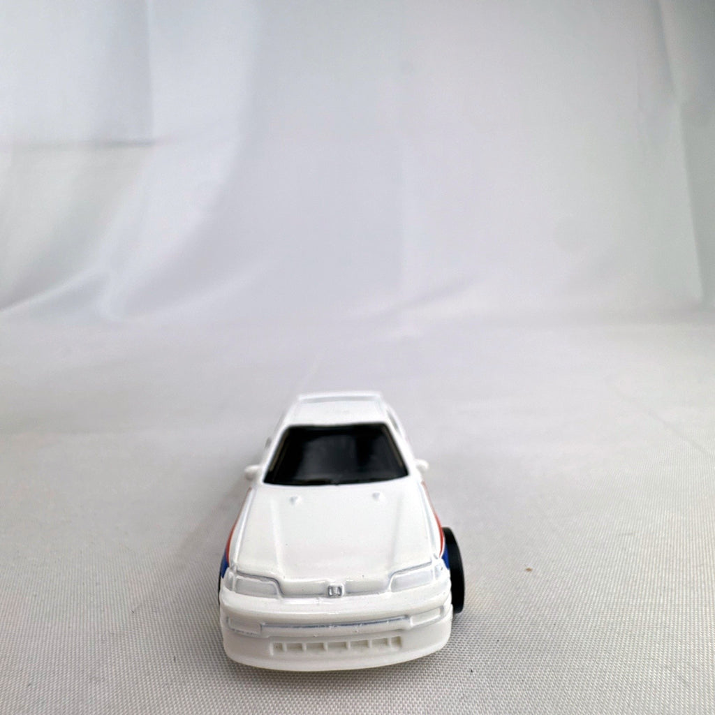 Hot Wheels 1988 Honda CRX diecast car in white HW Speed Graphics racing livery with gold wheels.