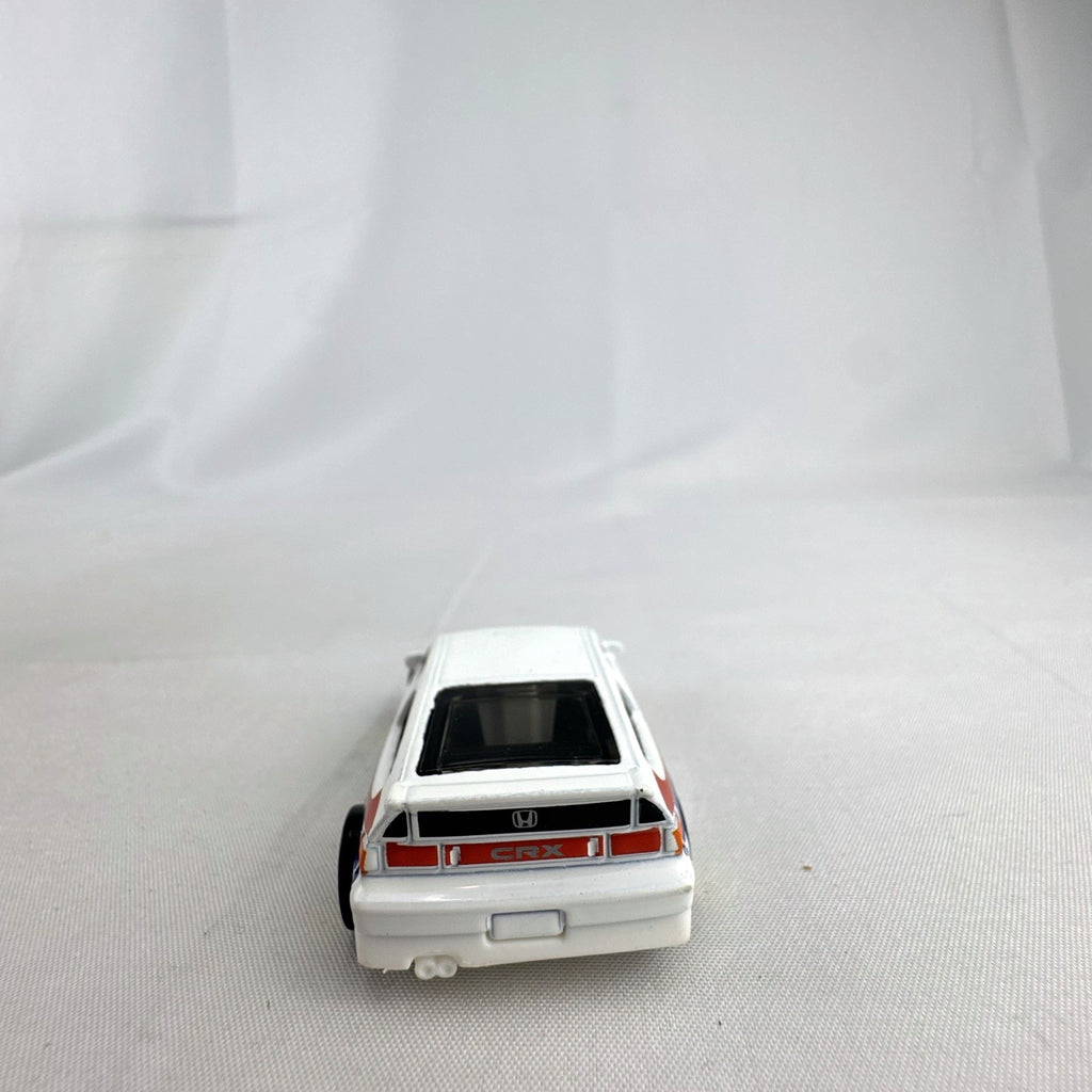 Hot Wheels 1988 Honda CRX diecast car in white HW Speed Graphics racing livery with gold wheels.