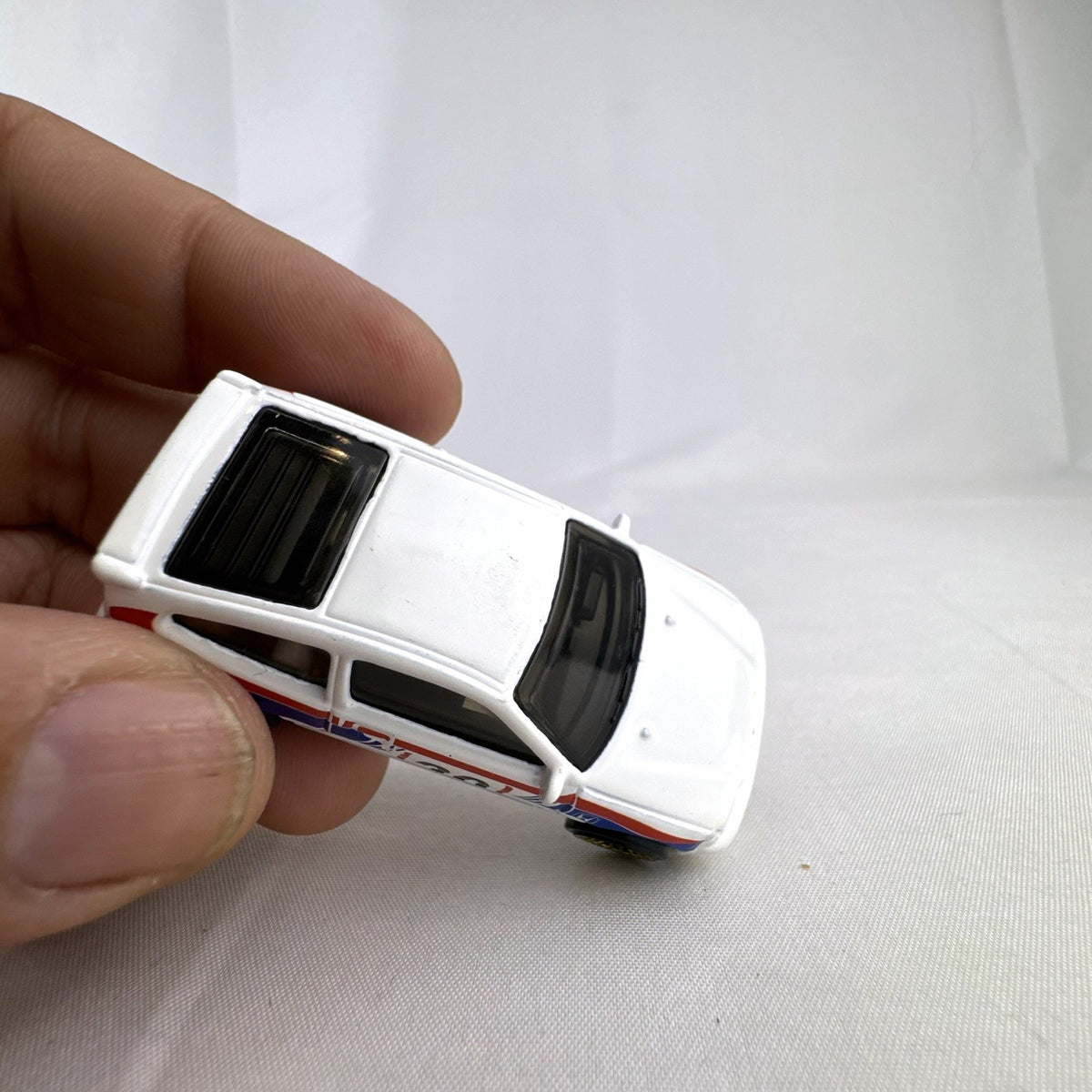 Hot Wheels 1988 Honda CRX diecast car in white HW Speed Graphics racing livery with gold wheels.
