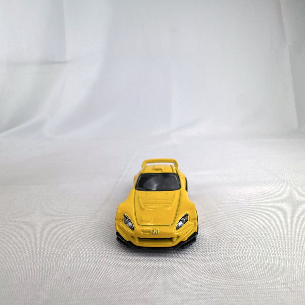 Yellow 1:64 scale Hot Wheels Honda S2000 diecast car featuring Ryu Asada tribute graphics