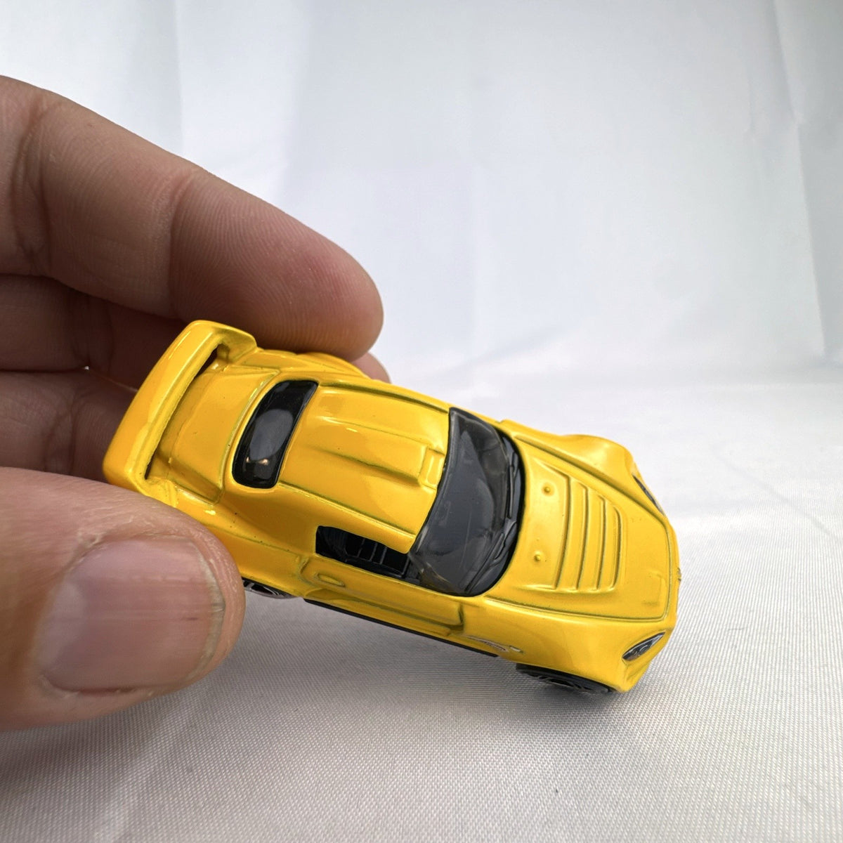 Yellow 1:64 scale Hot Wheels Honda S2000 diecast car featuring Ryu Asada tribute graphics