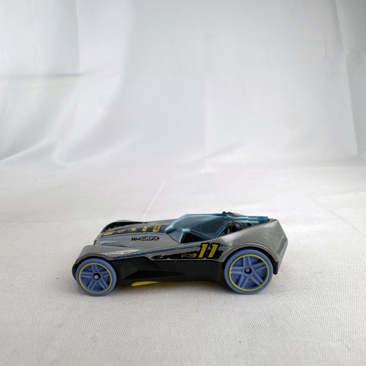 Hot Wheels Covelight 1:64 scale diecast car in silver and black with #11 race graphics