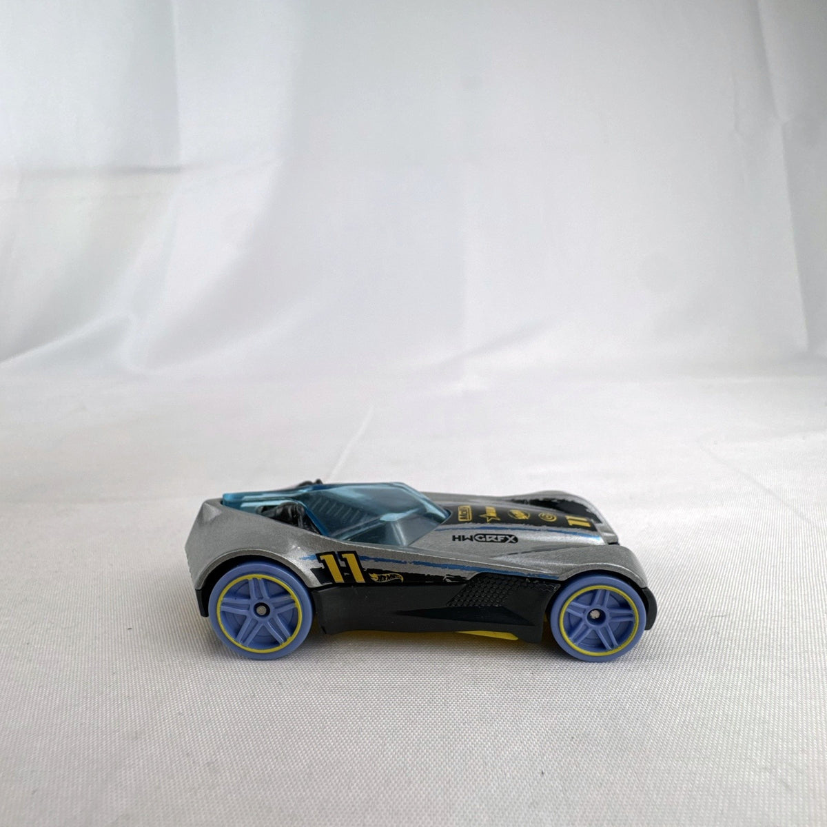 Hot Wheels Covelight 1:64 scale diecast car in silver and black with #11 race graphics